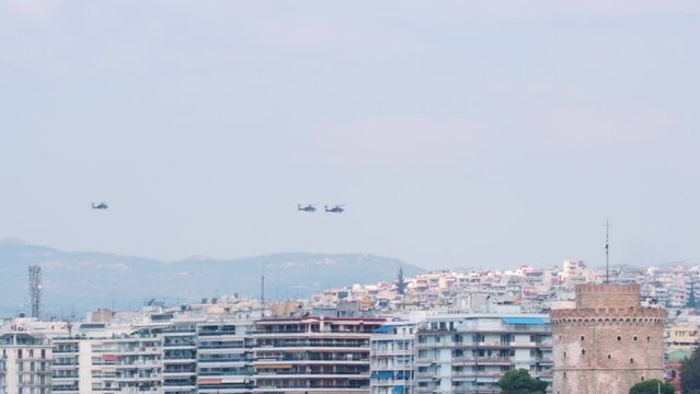 Greek Air Force helicopters flying in formation above a city. Air show in Thessaloniki, Greece during the 28 October National Oxi Day parade.