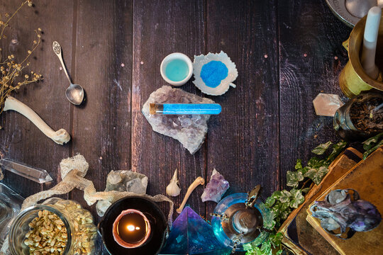 Blue Vitriol of Venus (the alchemical name for copper). Crystals of Copper Sulfate Pentahydrate in solid and dissolved form. Alchemy ingredient. Ancient salt of Venus. Wooden table background. Topview