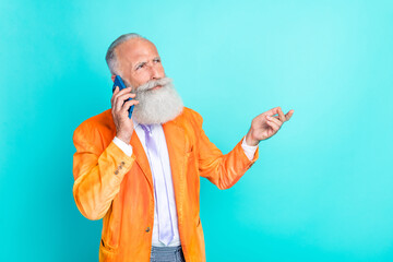 Photo of serious successful aged person speak communicate telephone isolated on turquoise color background