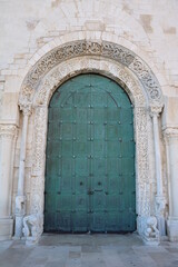 Green door to Cathedral San Nicola Pellegrino in Trani, Italy