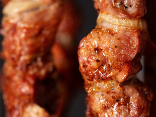 Cooking pork kebab in electrical barbecue on skewers