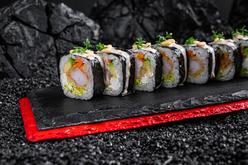 rolls with shrimp and avocado on a black background