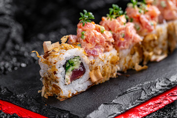 rolls with tuna and shavings on a black background