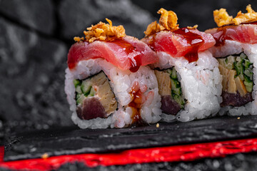 rolls with tuna on a black background