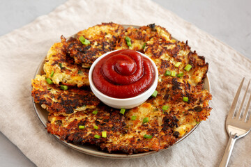 Homemade Cauliflower Cheddar Fritters with Chives on a Plate, side view.