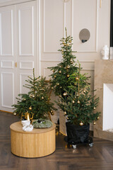 Fototapeta na wymiar Three stylish Christmas trees in a classic modern living room. Home interior for the holiday