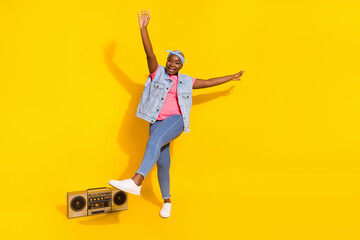 Full body photo of carefree cool lady enjoy dancing listen favorite song isolated on yellow color background