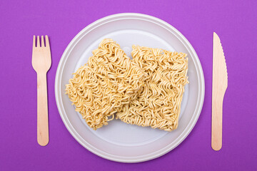 Uncooked Instant Noodles on White Plate. Raw Pasta. Dry Asian Fast Food. Quick Lunch