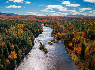 Colorful fall trees around the Saranac river near Redford in the Adirondacks in New York State in...
