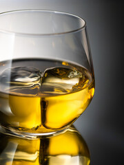 Whisky on the rocks, glass filled with ice cubes, close-up shot
