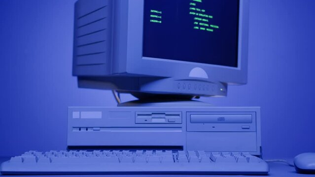 Retro pc with loading code console, programmer making scripts, green basic screen, Old computer studio blue night background close-up, Desktop vintage retro wave display, late 90s PC.