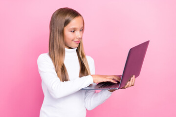 Fototapeta premium Photo of positive intelligent person hold use wireless netbook write typing isolated on pink color background