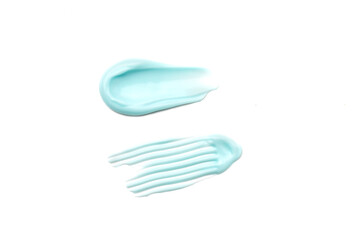 Textured smears anti aging skin cream or body lotion for skin care on white background. Pastel blue cream gel cosmetic smudge texture