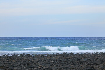 Look at the beautiful waves on the beach of Jeju Island.