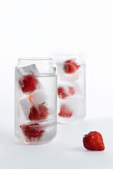 Refreshing drinks with strawberries in ice on a white background