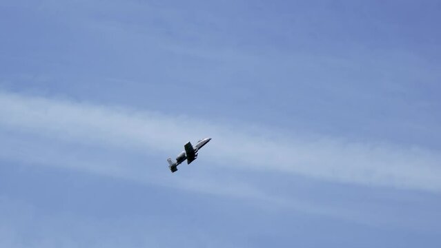 A10 Thunderbolt jet plane an US Air Force gunship in grey colour scheme against a blue sky, slow motion