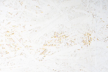 Oriented strand board OSB painted white. Background of rough surface made of compressed sawdust. Construction backdrop
