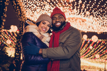 Portrait of attractive cheerful couple having fun visiting eve carnival party occasion fair free...