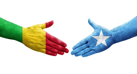 Handshake between Mali and Somalia flags painted on hands, isolated transparent image.