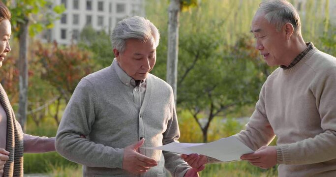 Senior Chinese Man Giving Out Flyers In The Park,4K