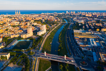 Picturesque aerial view of Besos river with Barcelona modern neighborhood of Sant Adria on its banks overlooking blueness