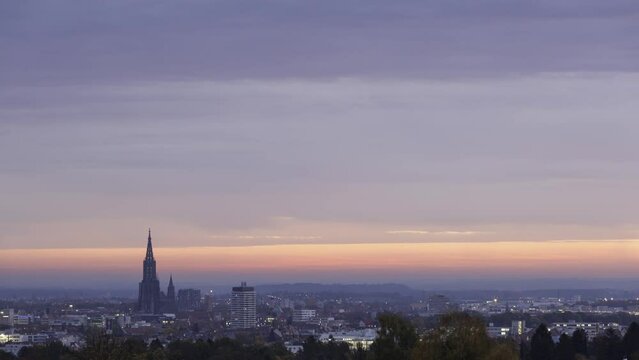 Inner city of Ulm and Ulm minster at colorful sunset with clouds time lapse