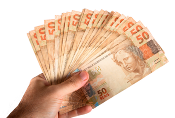 Hand holding fifty dollar bills. Brazilian money. png transparent background