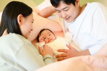 Young Asian mom and dad crying in the bedroom