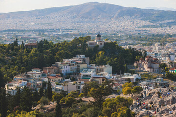 Fototapeta premium Athens, Attica, beautiful super-wide angle view of Athens city, Greece, Mount Lycabettus, mountains and scenery beyond the city, seen from The Parthenon, temple on the Athenian Acropolis