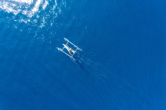 Aerial view of a traditional fishing boat sailing in ocean, Lombok, West Nusa Tenggara, Indonesia