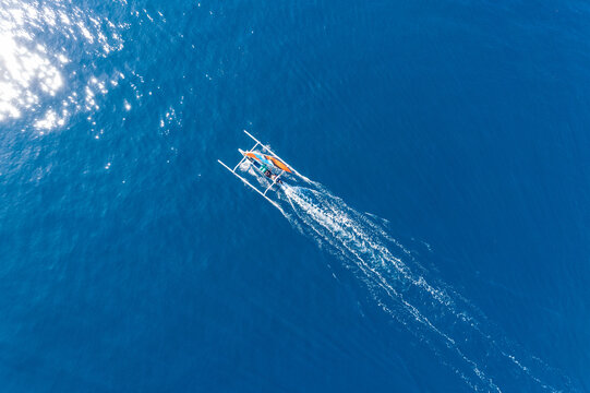 Aerial view of a traditional fishing boat sailing in ocean, Lombok, West Nusa Tenggara, Indonesia