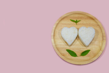There are two heart-shaped rice in a bowl representing steadfast and pure love.