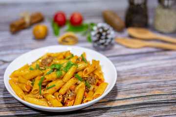 My favorite dish is penne pastas with ketchup eggs and pork on the table ready to serving for today's dinner.