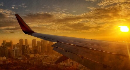 airplane flying over the sunset