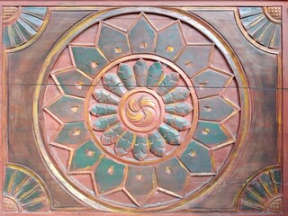 old ornament, the mosaic of the sun in the wood paint