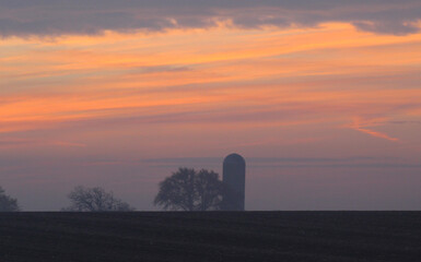 sunset farm in the fog 