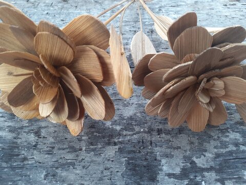 Handycraft bamboo. The art of traditional Indonesian bamboo crafts. Bamboo flowers. Homemade. Wooden background.