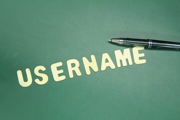 pen and wooden letters with the word username. user concept