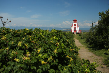 Phare de St-Andr&eacute;-de-Kamouraska lighthouse with path on the shore of St-Laurence river, Bas St-Laurent. Quebec Canada