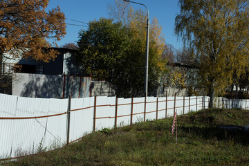 White fence around area. Fenced field details. Steel profile fence.