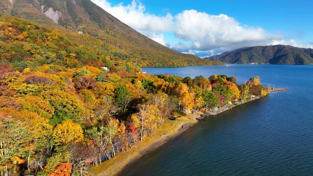 flying above lake Chuzenji in Nikko region, Japan in autumn, flying above autumn sunshine landscape in Japan