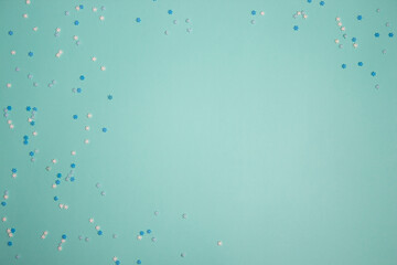 White and blue confetti over the mint background with copy space.