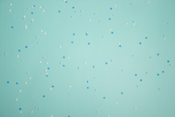 Blue and white  confetti snowflakes over the mint background. 