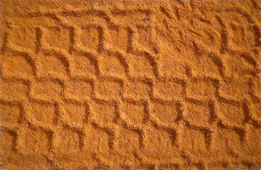 pattern of tracks on orange dirt