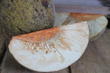 sliced of breadfruit on a wooden table portrait