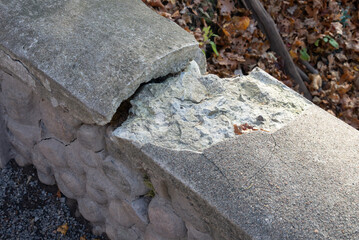 A cracked stone concrete wall