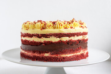 Homemade Red Velvet cake with cream cheese frosting on Cake Stand Rustic decoration style.