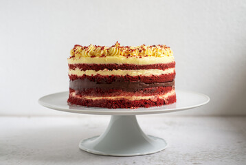 Homemade Red Velvet cake with cream cheese frosting on Cake Stand Rustic decoration style.