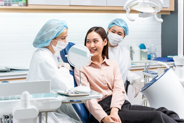Orthodontist doctor examine tooth to woman patient at dental clinic.