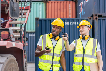 African American and Caucasian man worker work in container terminal.